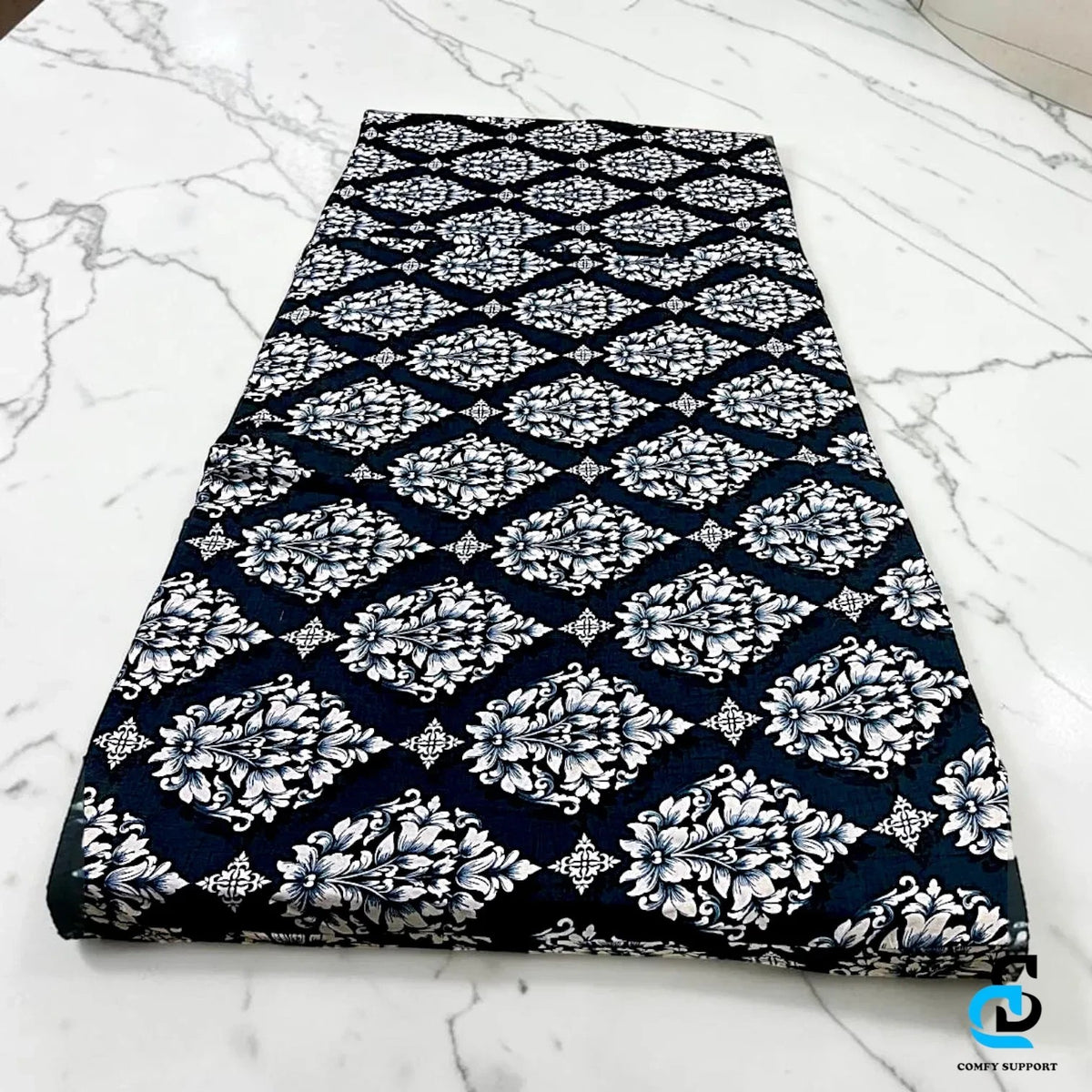 Comfy Support folding mattress cover featuring a black and white damask floral pattern on a marble surface