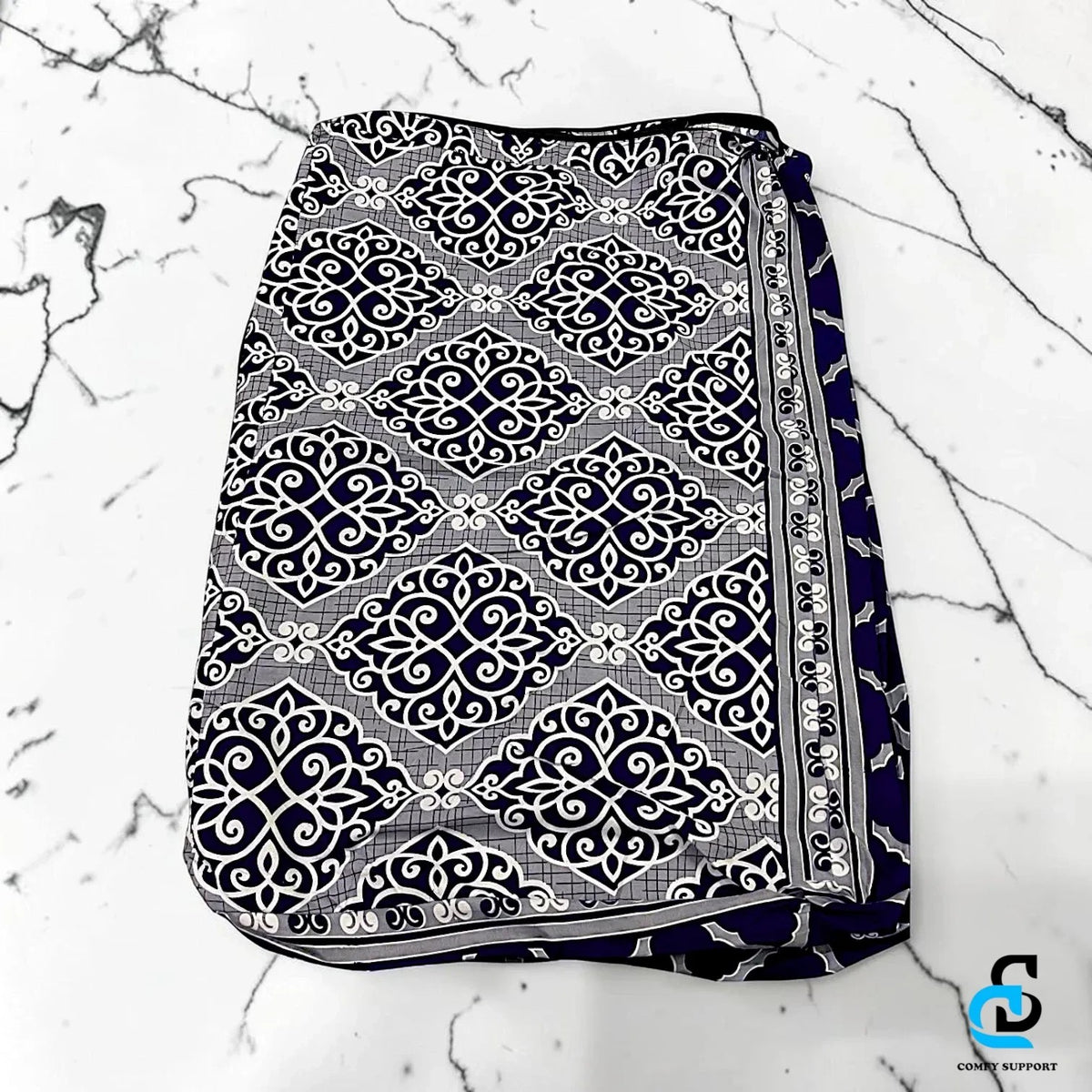 Comfy Support folding mattress cover featuring a navy blue and white intricate damask pattern on a marble surface
