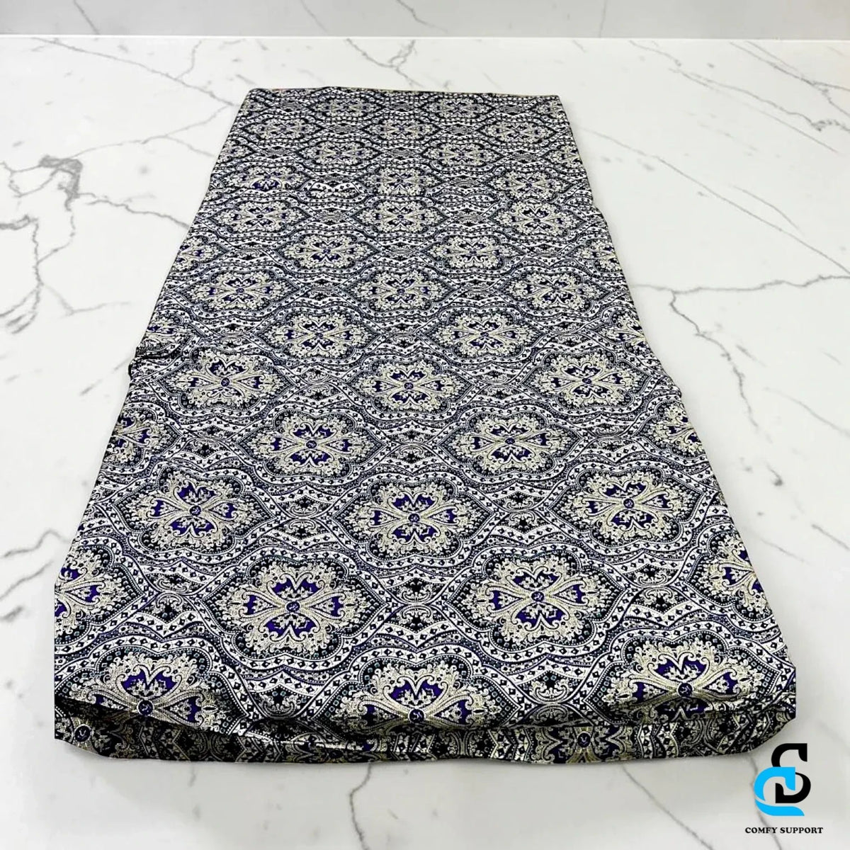 Comfy Support folding mattress cover featuring a decorative blue and white geometric damask pattern on fabric