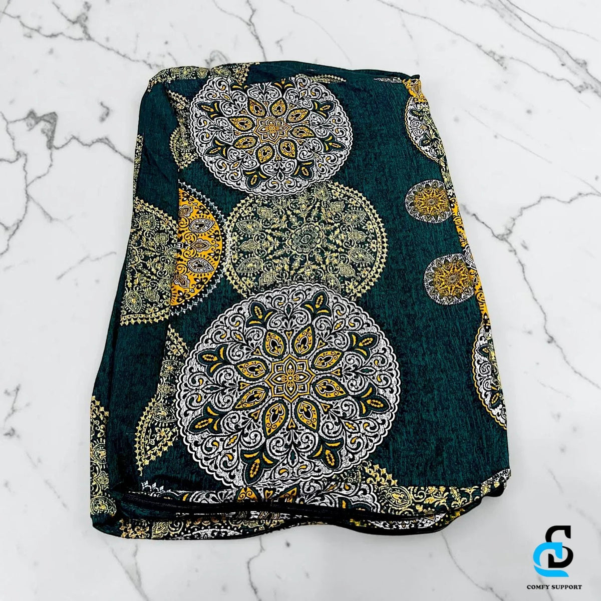 Comfy Support folding mattress cover in a dark green fabric with intricate white and yellow mandala patterns.